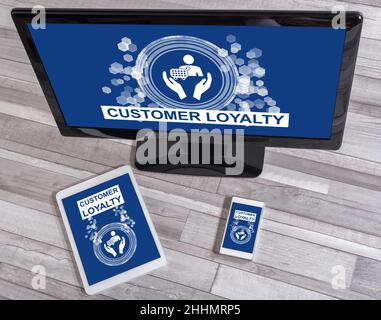 Customer loyalty concept shown on different information technology devices Stock Photo