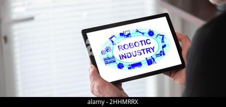 Robotic industry concept shown on a tablet held by a man Stock Photo