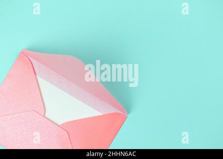 Valentine day greeting concept with envelope on blue background top view. Flat lay Stock Photo