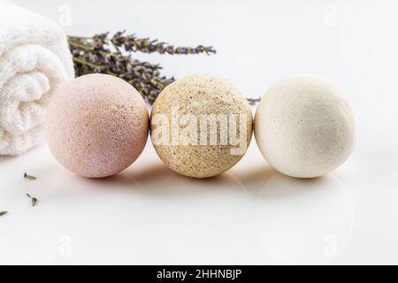 Homemade salt bath bombs with dry lavender flowers and white towel. Natural cosmetics Stock Photo