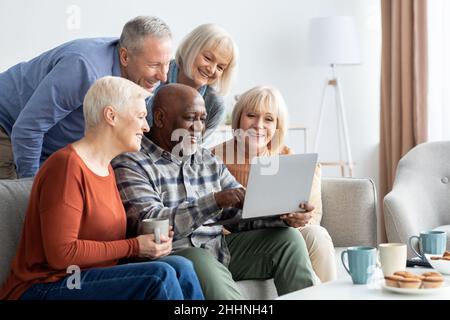 Happy elderly people spending time together at home Stock Photo