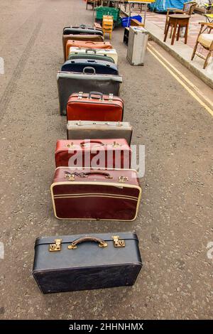 Suitcases for sale at Barras market lined up in street. Stock Photo