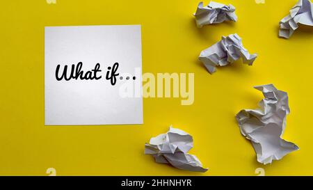 What if text on notepad with trash papers and yellow background. Motivational concept. Stock Photo