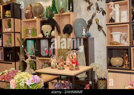 Decorative ceramic vase. Beautiful floral arrangement of af artificial plant in flower pot. Stylish Interior composition in home design Stock Photo