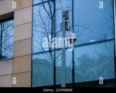 CCTV camera isolated on pillar with glass background Stock Photo