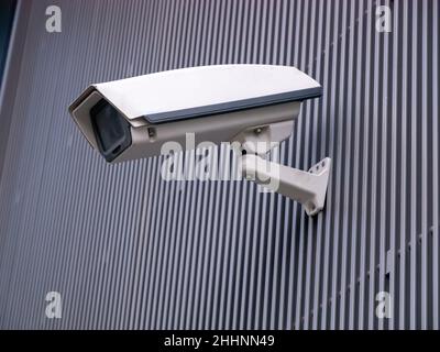 CCTV camera isolated on gray striped background. Stock Photo