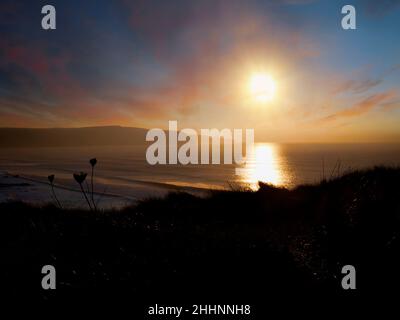 Winter sun over the Cornish coast, Widemouth Bay, Cornwall, UK Stock Photo