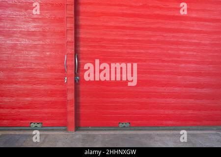 Metal lock and door handle on the red wooden door. Abstract red wood planks background wall texture. Wooden texture red colour for backdrop. Red textu Stock Photo