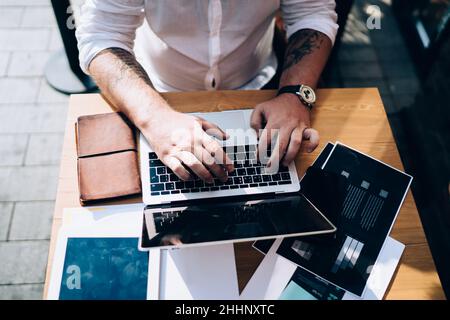 Businessman working with laptop and documents in cafe Stock Photo