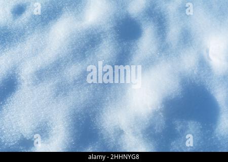 Background of snow illuminated by sunlight, flat texture Stock Photo