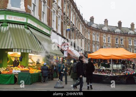 London, UK, 25 January 2022: On Electric Avenue in Brixton people buy groceries from shops and market stalls that cater to the diversity of the local population. The cost of basic foods has risen sharply and there are fears of how the cost of living crisis will affect poorer households all around the country. Anna Watson/Alamy Live News Stock Photo