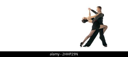 Horizontal flyer with flexible young dancers dancing Argentine tango isolated on white studio background. Artists in black stage costumes Stock Photo