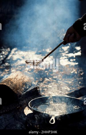 Cooking outdoors over fire Stock Photo