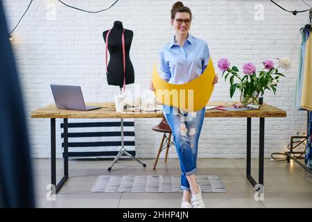 Young smiling woman working in atelier Stock Photo