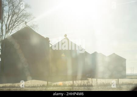 View of grain bins from car window in rural Illinois Stock Photo