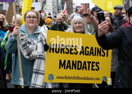 Anti Vax protest Deansgate. Protester holding sign text Nurses Against Mandates. Manchester UK Stock Photo