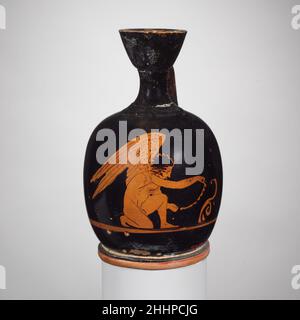 Terracotta squat lekythos (oil jar) late 5th century B.C. Greek, Attic Kneeling Eros.. Terracotta squat lekythos (oil jar)  247345 Stock Photo