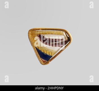 Glass striped mosaic bowl fragment late 1st century B.C.–early 1st century A.D. Roman Rim fragment.Translucent cobalt blue, purple, opaque white, yellow, with colorless glass.Applied coil rim with slightly beveled, vertical lip; almost straight side, tapering slightly at bottom. Rim in colorless glass with fine double spiral thread; body decorated with wavy bands slanting from top left to right, forming a regular pattern: purple, blue, colorless with double spiral yellow thread, white, purple with three white lines, and white.Some pinprick bubbles; exterior polished, with pitting of surface bu Stock Photo