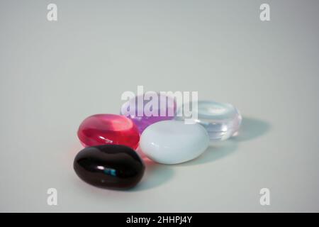 close-up of bitter glass cubes on a white background. One black glass stone.Product photo Stock Photo