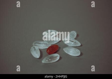 Clear and colored glass crystals are scattered on the table. Close-up, top view Stock Photo