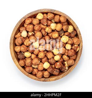 Peeled hazelnuts in wooden bowl isolated on white background top view. Stock Photo