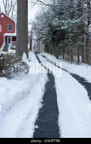 cleaned car tracks in the driveway after the snow storm Stock Photo