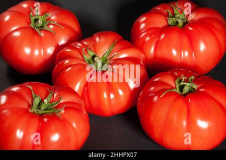 pink tomato on black background Stock Photo