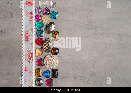 multi-colored sewn stones on a grey background.Copy Space Stock Photo
