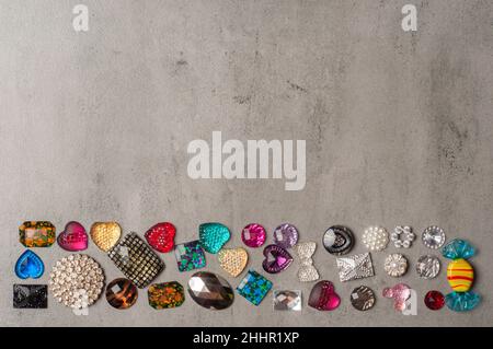 multi-colored sewn stones on a grey background.Copy Space Stock Photo