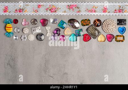 multi-colored sewn stones on a grey background.Copy Space Stock Photo
