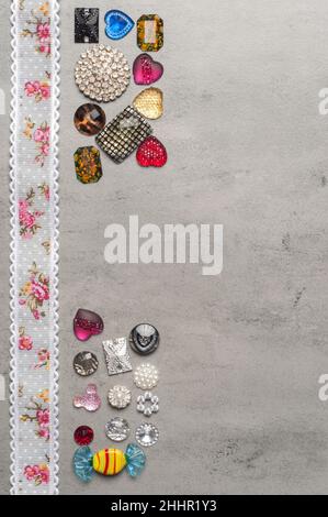 multi-colored sewn stones on a grey background.Copy Space Stock Photo