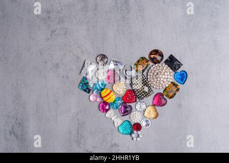 multi-colored sewn stones on a grey background.Copy Space Stock Photo