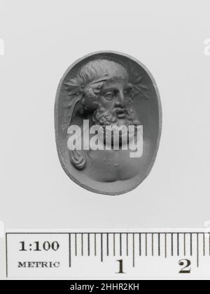 Amethyst ring stone with a bust of Dionysos 1st–2nd century A.D. Roman The god of wine is depicted as an older man with a full beard and wearing a wreath of vine leaves. Amethyst ring stone with a bust of Dionysos. Roman. 1st–2nd century A.D.. Amethyst. Early Imperial. Gems Stock Photo