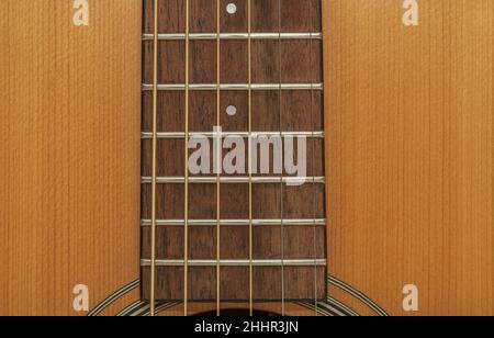 Closeup view of a six string acoustic guitar with wood grain Stock Photo