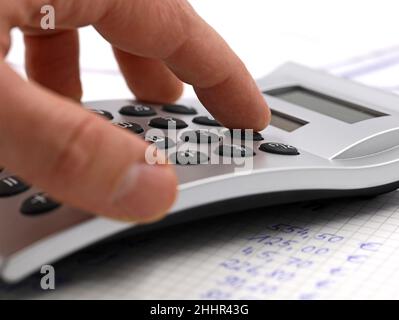 Male hand using silver calculator, close up, financial planing concept image Stock Photo
