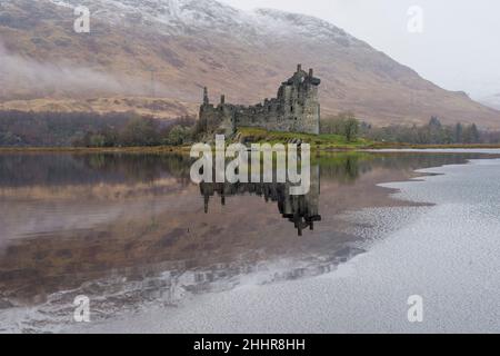 Kilchurn castle on Loch Awe is seen partially frozen as low temperatures in the Met weather amber warning for snow and ice.  Credit: Euan Cherry Stock Photo