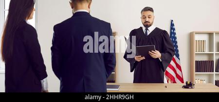 American judge stands up and gives his judgment during a court trial in the US courthouse Stock Photo