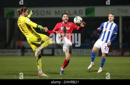 Charlton Athletic's Conor Washington (centre) and Hartlepool United goalkeeper Ben Killip (left) battle for the ball during the Papa John's Trophy quarter-final match at Victoria Park, Hartlepool. Picture date: Tuesday 25th January, 2022. Stock Photo