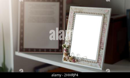 Mockup of a picture frame on a shelf with white space Stock Photo