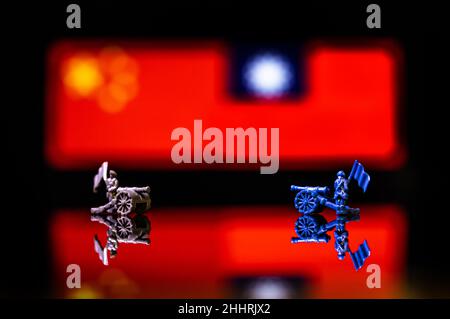 Conceptual image of war between China and Taiwan using toy soldiers and national flags on a reflective background Stock Photo