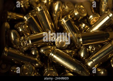 Closeup of a pile of 9 mm pistol bullets. Gun ammunition. Stock Photo