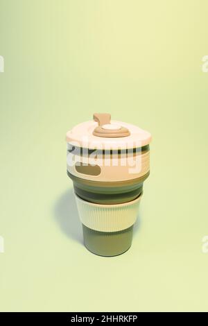 Reusable silicone cup for coffee on a light background. Vertical photo Stock Photo