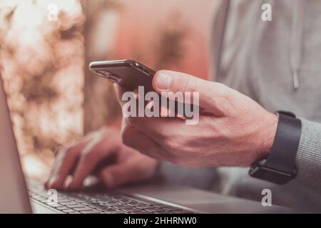 Freelancer using mobile smart phone in home office, selective focus Stock Photo
