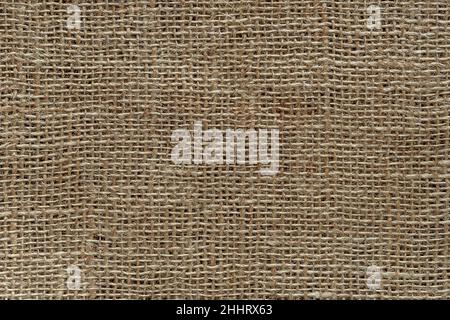 Burlap fabric texture macro. Background of coarsely woven sackcloth from jute, hemp or flax. Design element for rustic country style. Brown tan сanvas Stock Photo