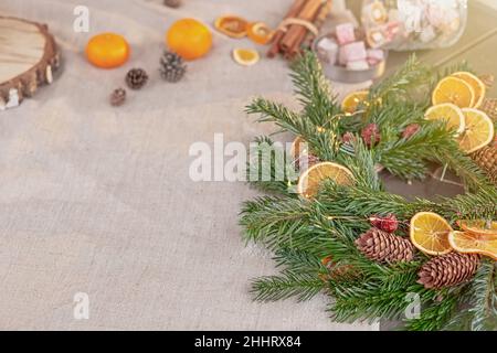 Wide banner with natural spruce wreath on a fabric tablecloth Stock Photo