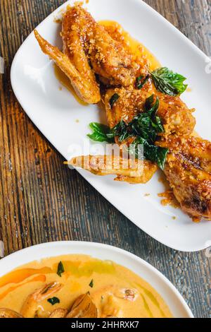 fried chicken at thai restaurant with crispy basil Stock Photo