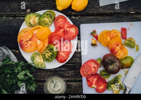 sliced red, yellow, green heirloom tomatoes Stock Photo