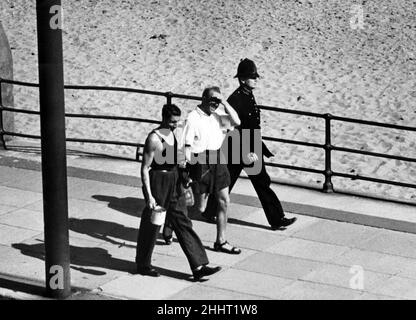 Police guard an internee, Isle of Man. 7th June 1942. Stock Photo