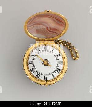 Watch probably ca. 1655–60 Watchmaker: Charles Bobinet Rock crystal was not the only mineral used for making watchcases, and Charles Bobinet was noted for supplying movements for cases of various kinds of hardstones. The cases often exploited the pattern of the stone, as is evident in this watch. Equally effective is the pristine enamel dial, clearly calibrated to show fifteen-minute intervals indicated by the single hand. These dials were derived from those of the enameled watchcases originally developed in France.. Watch  194205 Stock Photo