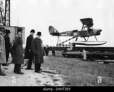 The Prime Minister, Winston Churchill, with Captain D. Margesson (Secretary of State for War) watching preparations being made for the launching of a 'Queen Bee' seaplane which is flown by wireless control without a pilot.9th June 1941 Stock Photo